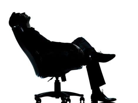 one caucasian business man relaxing thinking sitting in armchair silhouette Full length in studio isolated on white background