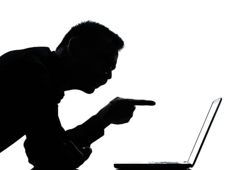 one caucasian business man computing computer laptop pointing portrait silhouette in studio isolated on white background