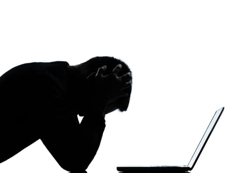 one caucasian business man computing computer laptop despair sad portrait silhouette in studio isolated on white background