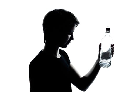 one caucasian young teenager silhouette boy or girl portrait holding empty vodka alcohol bottle in studio cut out isolated on white background
