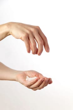 Hands sprinkling salt against white background