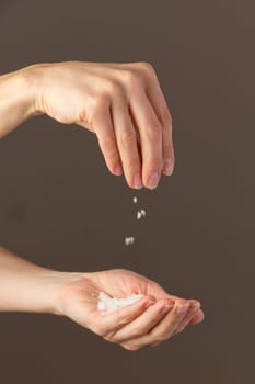 Hands sprinkle salt