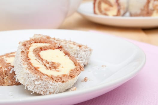 Swiss Sponge Roll Dessert With Cream on White Plate - Shallow Depth of Field