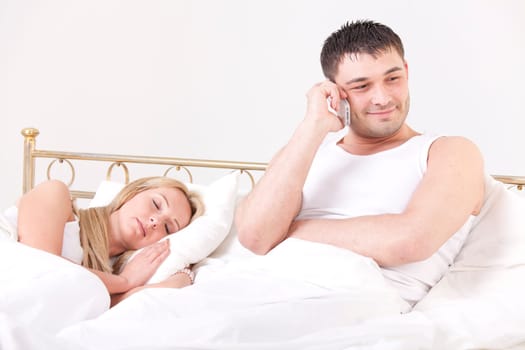 couple in bed - man cheating while a woman sleeping