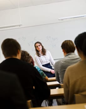 Schoolteacher in front of pupils in the classroom