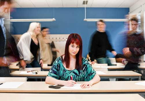 Working girl among moving pupils at the end of the Class