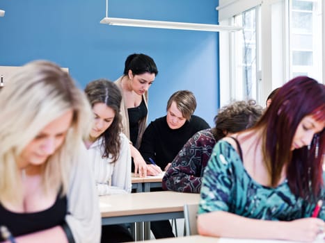 Teacher and young Adult students in the classroom