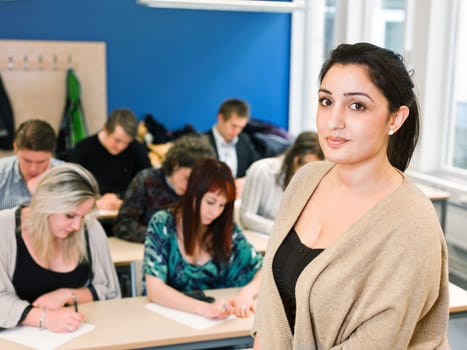 Schoolteacher in front of pupils in the classroom
