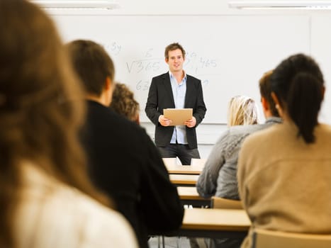 Schoolteacher in front of pupils in the classroom