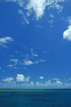 ocean scene, blue sky with white clouds, great barrier reef