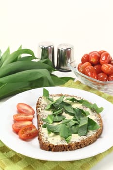 a slice of wholemeal bread with butter and wild garlic
