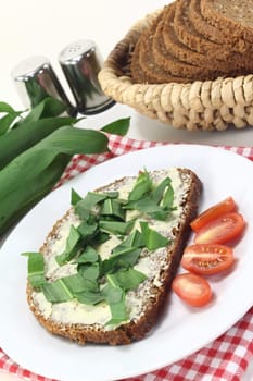 a slice of wholemeal bread with butter and wild garlic