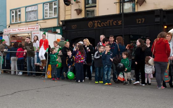 MALLOW, IRELAND - MARCH 17: unidentified crowd watching the St. Patrick&#039 s Parade on March 17, 2012 in Mallow, Ireland. This national Irish holiday takes place annually in March, event was held during the afernoon of March 17th 2012.