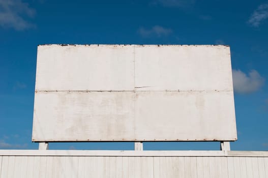 wooden billboard against a blue sky background