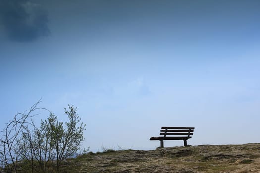 lonely bench on a rocky outcrop