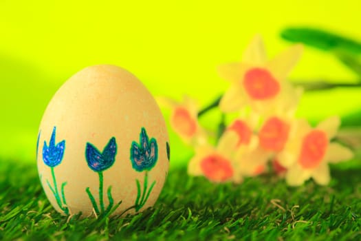 Easter decoration made of single,colorfully painted,Easter egg in green artificial grass
