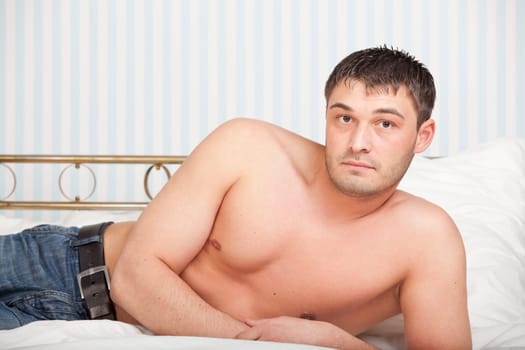 portrait of a man lying on the bed