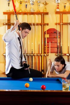 couple playing billiard expertise teacher and beautiful girl