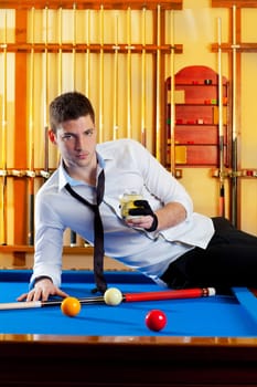 Billiard handsome player man drinking some alcohol in club