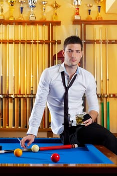 Billiard handsome player man drinking some alcohol in club