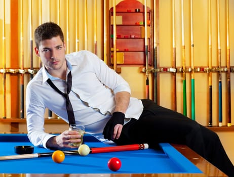 Billiard handsome player man drinking some alcohol in club
