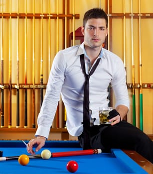 Billiard handsome player man drinking some alcohol in club