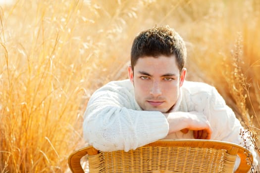 Autumn winter man portrait  in golden grass field with turtleneck sweater