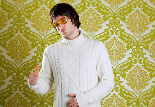retro hip young man with vintage glasses and winter  turtleneck sweater on wallpaper
