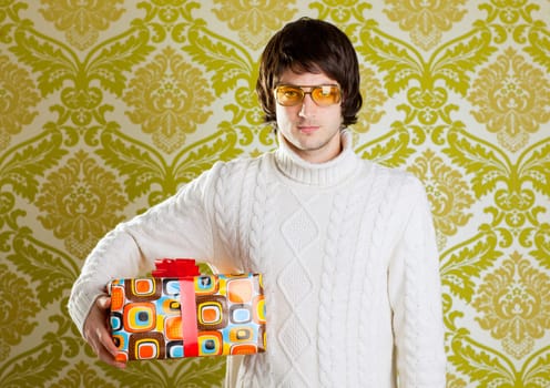 retro hip young man glasses holding  psychedelic gift box on wallpaper