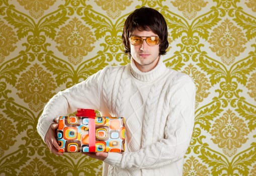 retro hip young man glasses holding  psychedelic gift box on wallpaper