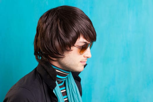 british indie pop rock look retro hip young man with sunglasses on blue