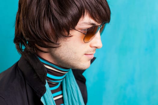 british indie pop rock look retro hip young man with sunglasses on blue