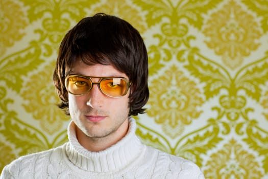 retro hip young man with vintage glasses and winter  turtleneck sweater on wallpaper