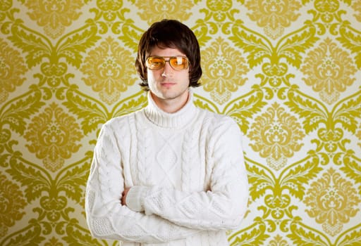 retro hip young man with vintage glasses and winter  turtleneck sweater on wallpaper