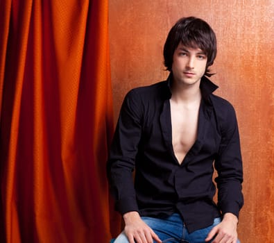 british indie pop rock look young man on orange brown retro background