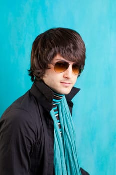 british indie pop rock look retro hip young man with sunglasses on blue