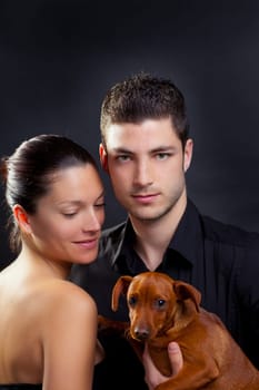 Couple in love with brown little pet puppy dog mini pinscher