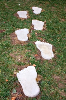big traces of foots in green grass