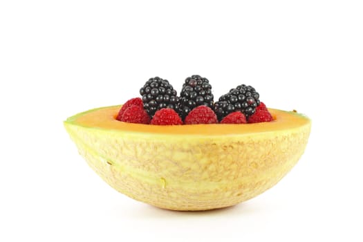 Blackberry and raspberry in melon isolated on white