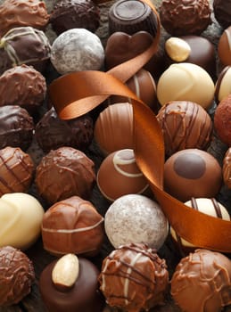 Different Truffles with a brown ribbon as a closeup