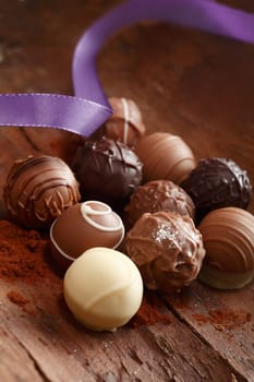Group Truffles with a purple ribbon on a wooden background