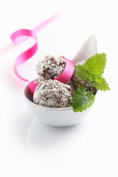 Truffles in a bowl with a bow isolated on white background