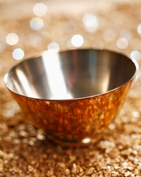Stylish empty silver bowl with reflections and a background bokeh of twinkling party lights