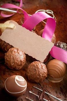 Handmade gourmet chocolates with a decorative pink ribbon and a luxury testured blank gift tag with a serrated edge