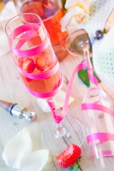 Elegant champagne flute filled with champagne and strawberries on a decorative table at a celebration
