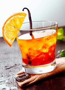 Cocktail Tequila sunrise on a wooden background with Orange Fruit, juice and some fresh leaves