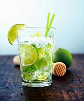 Refreshing cold Caipirinha with fresh lime slices and ice.