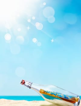 Message in a bottle illustrated with a beautiful sand beach in the background and a blue sky with awesome bokeh, maybe for your individual summer concept
