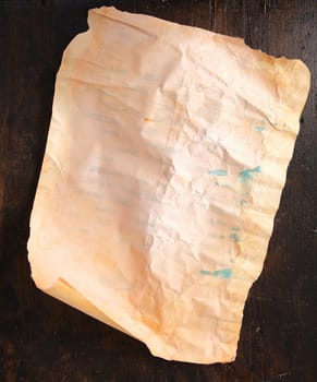 Brown vintage paper on an old and aged wooden background