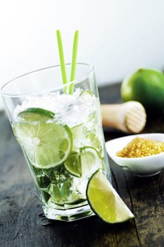 Caipirinha drink with brown sugar and a mortar on wooden background. Many other cocktails in my portofolio.